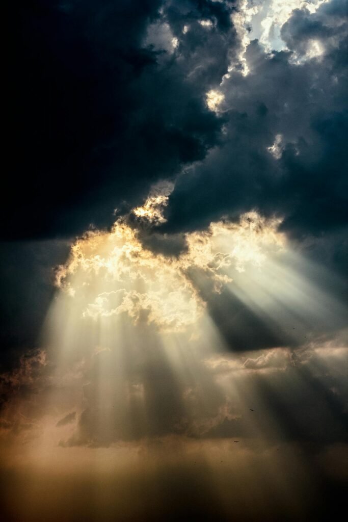 pexels-photo-325117-325117 Sun rays piercing through dark clouds create a dramatic sky scene.